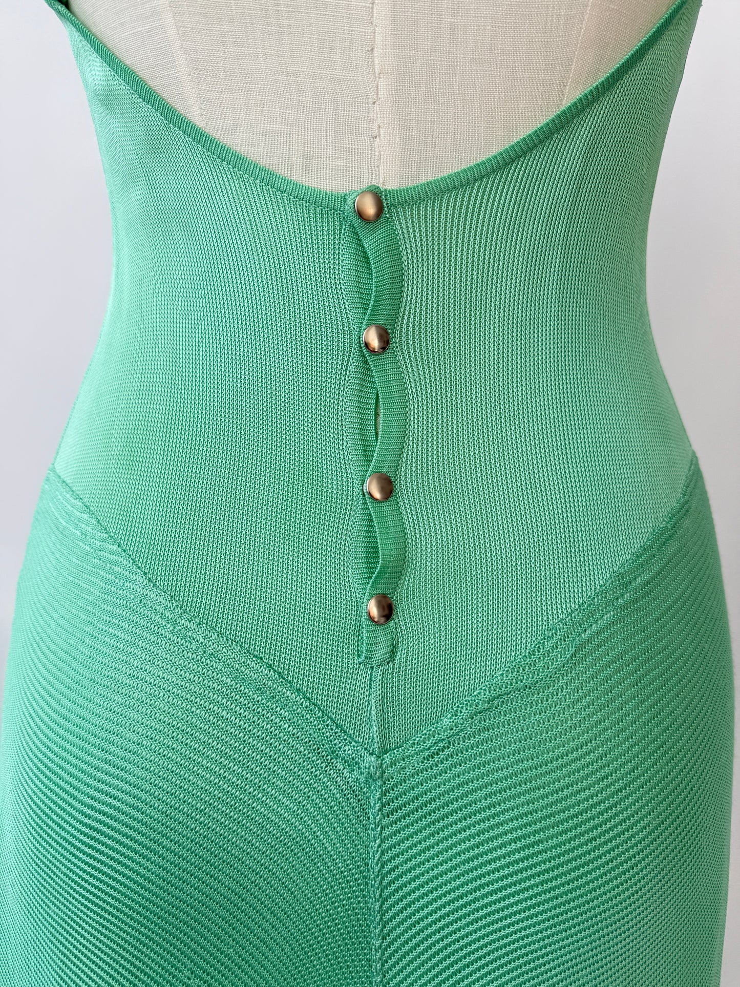 A close up of the buttons on the back against a white background.