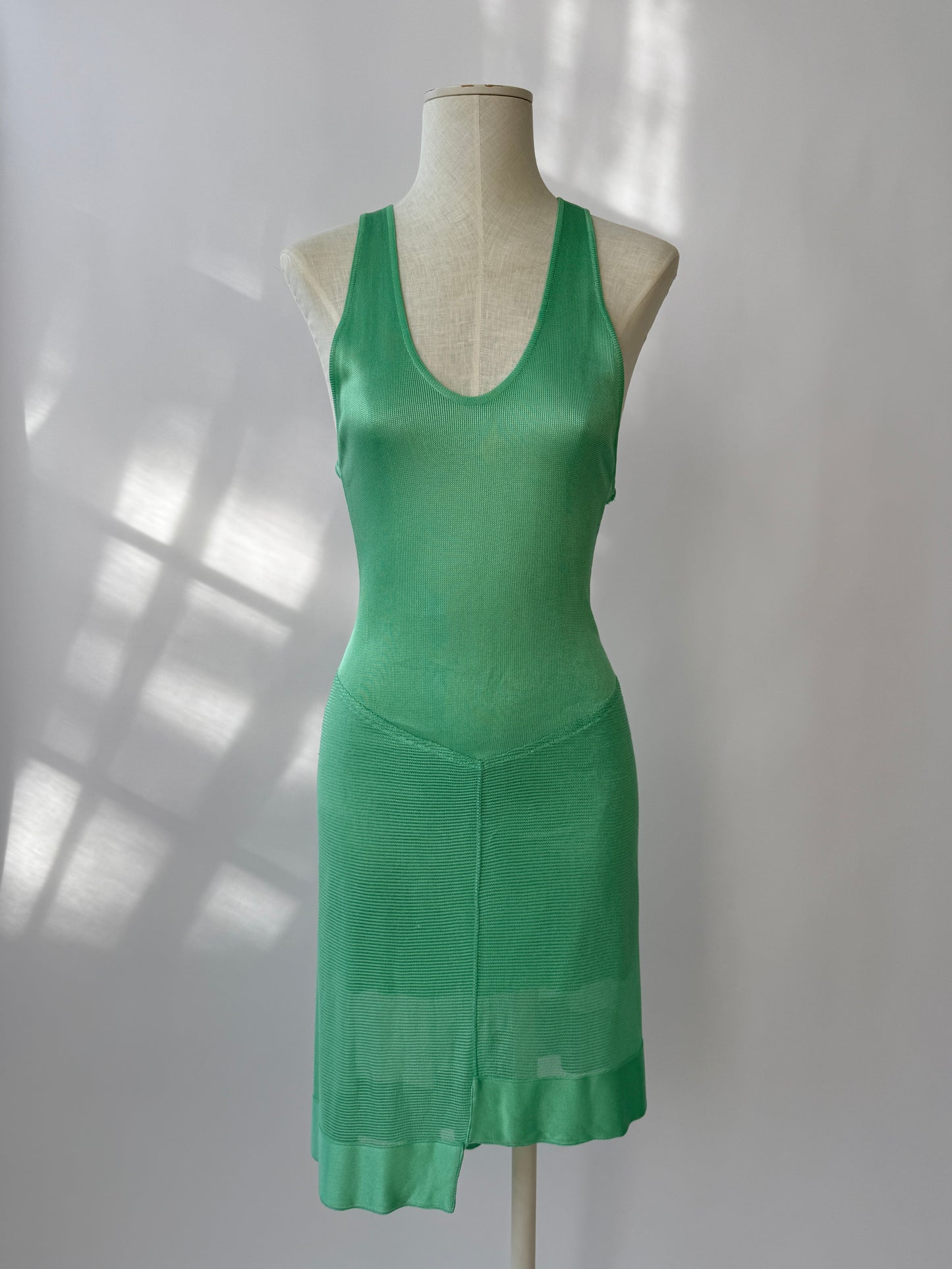 The dress seen from the front on a mannequin buste against a white background.