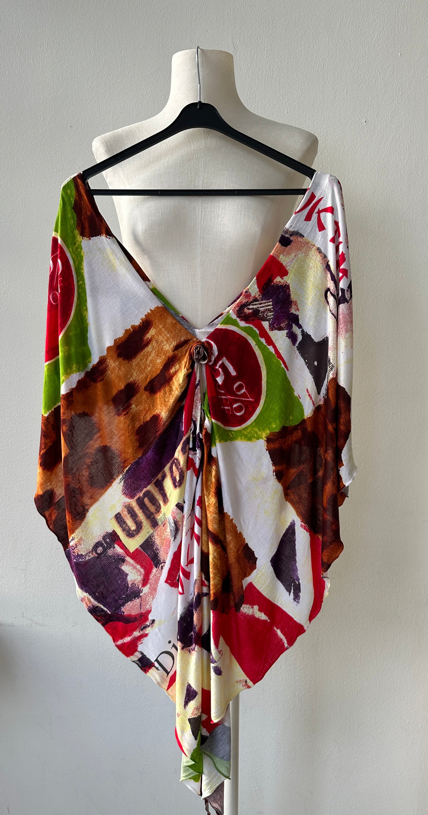 Christian Dior by John Galliano S/S 2003 "Victim" Draped Top shown on a hanger.