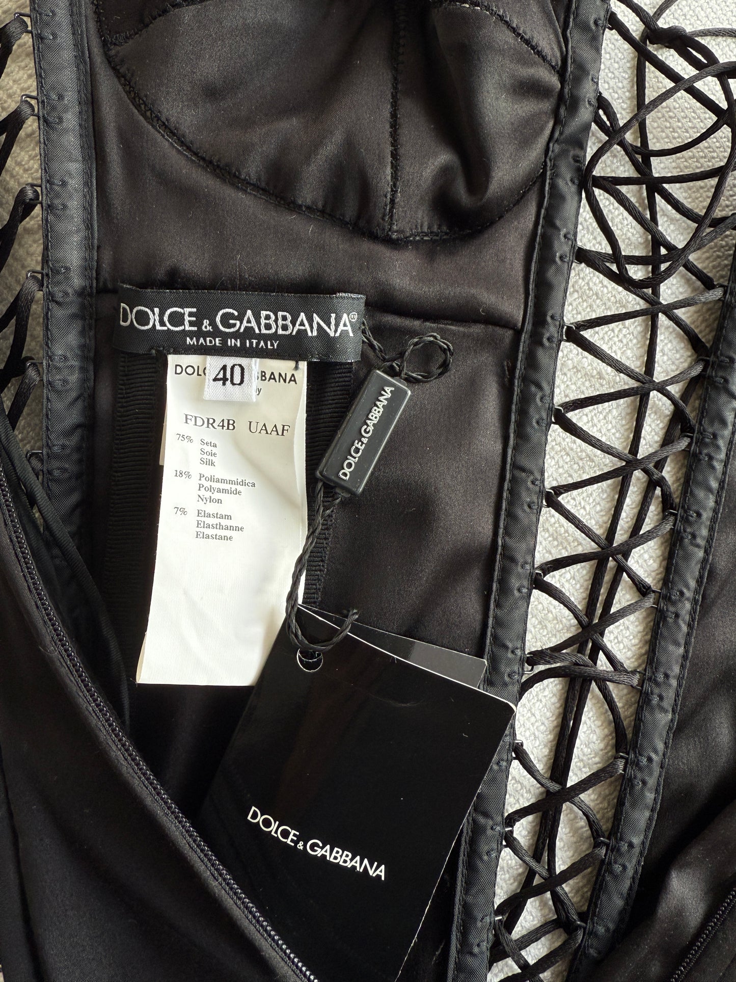 The brand and care label of the Dolce & Gabbana lace up dress