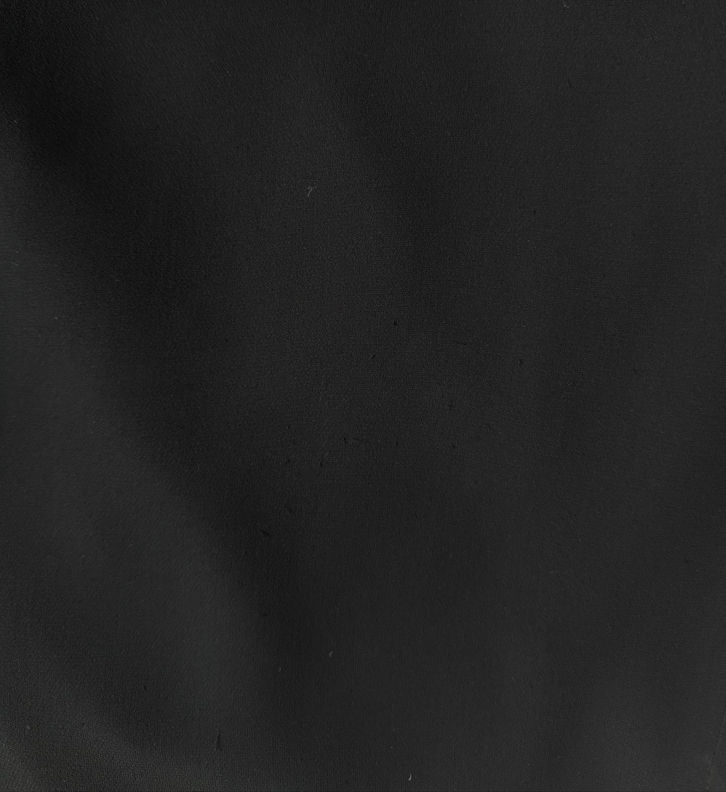 A zoomed-in photograph showcasing the silk fabric of the Emanuel Ungaro vintage dress.