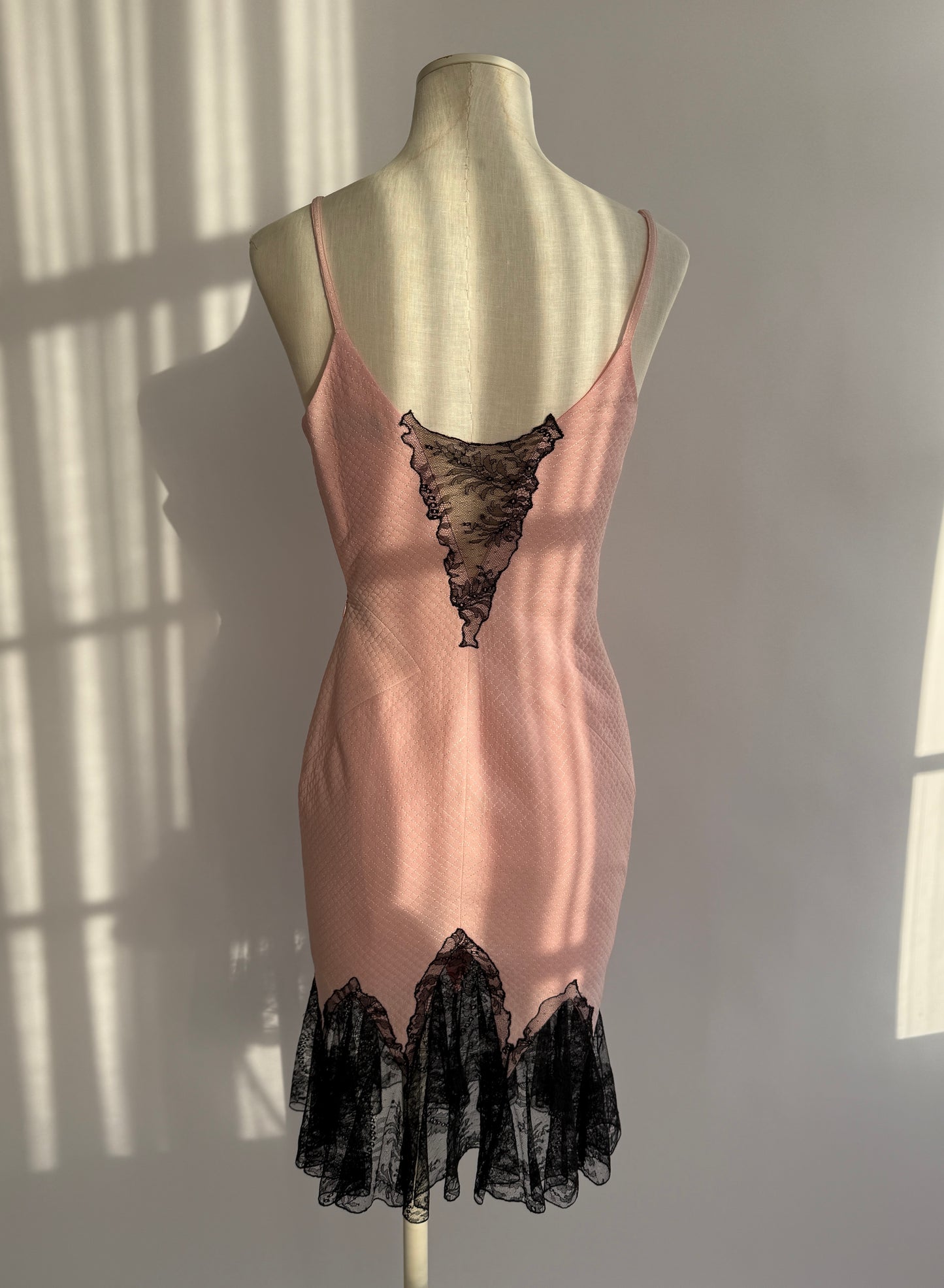 Back view of vintage Versace 2002 dress showing open back and lace fishtail hem.