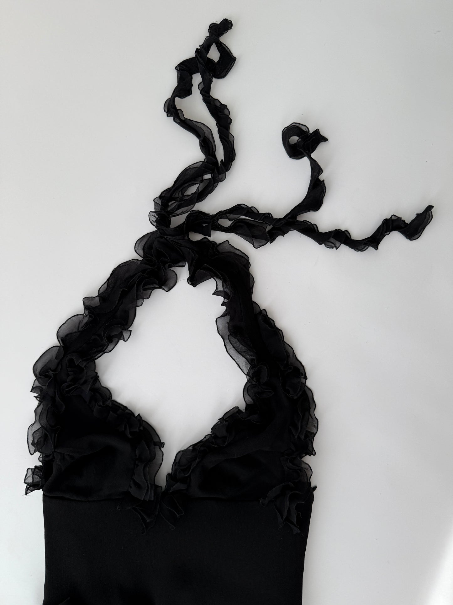 Close-up of the ruffled silk detailing on the Versace 2004 asymmetric dress.