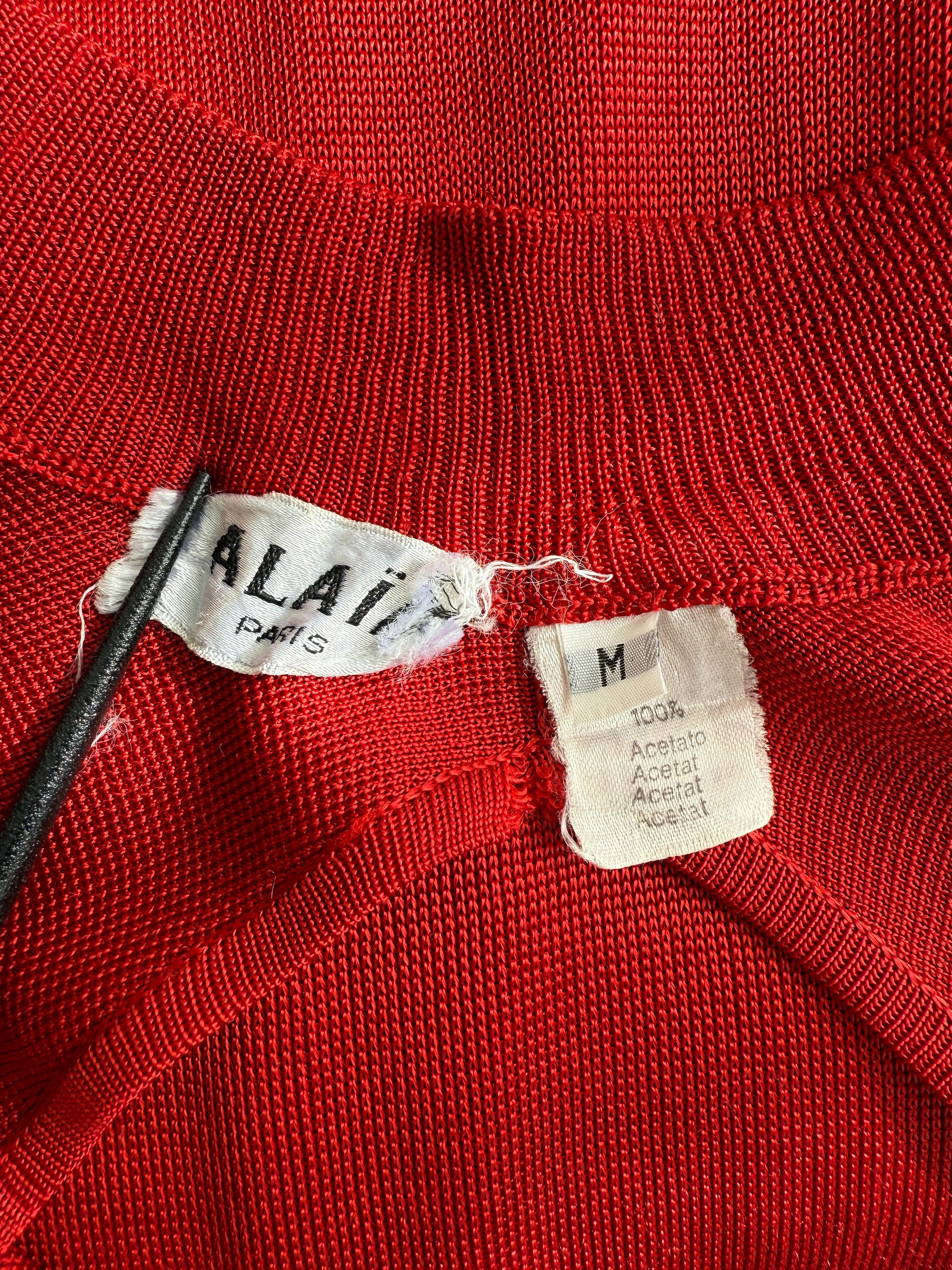 Closeup of the brand label and size tag of the Alaia dress