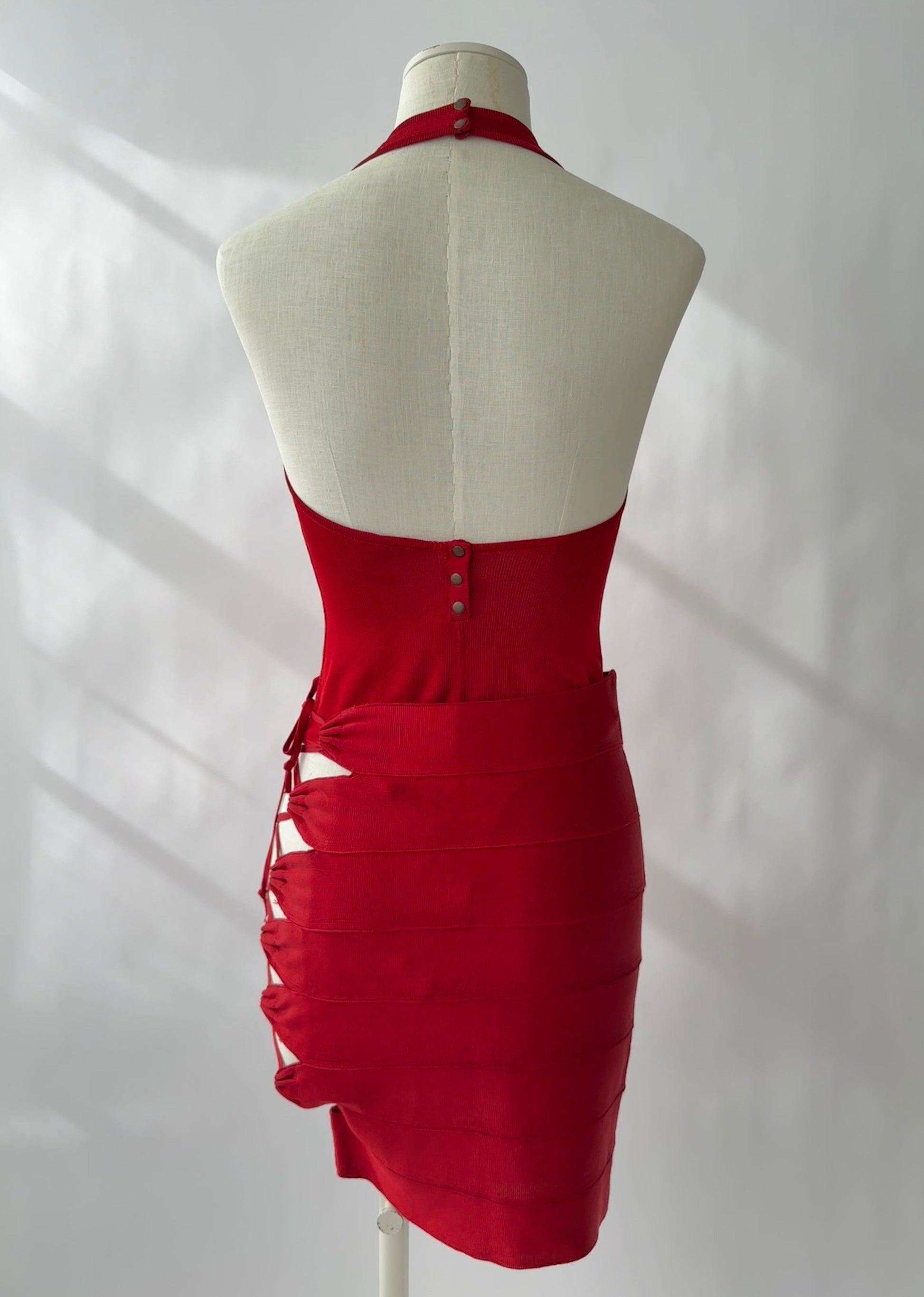 Azzedine Alaia 1986 lace-up skirt and halter neck bodysuit set in vibrant red, showcased from the back.