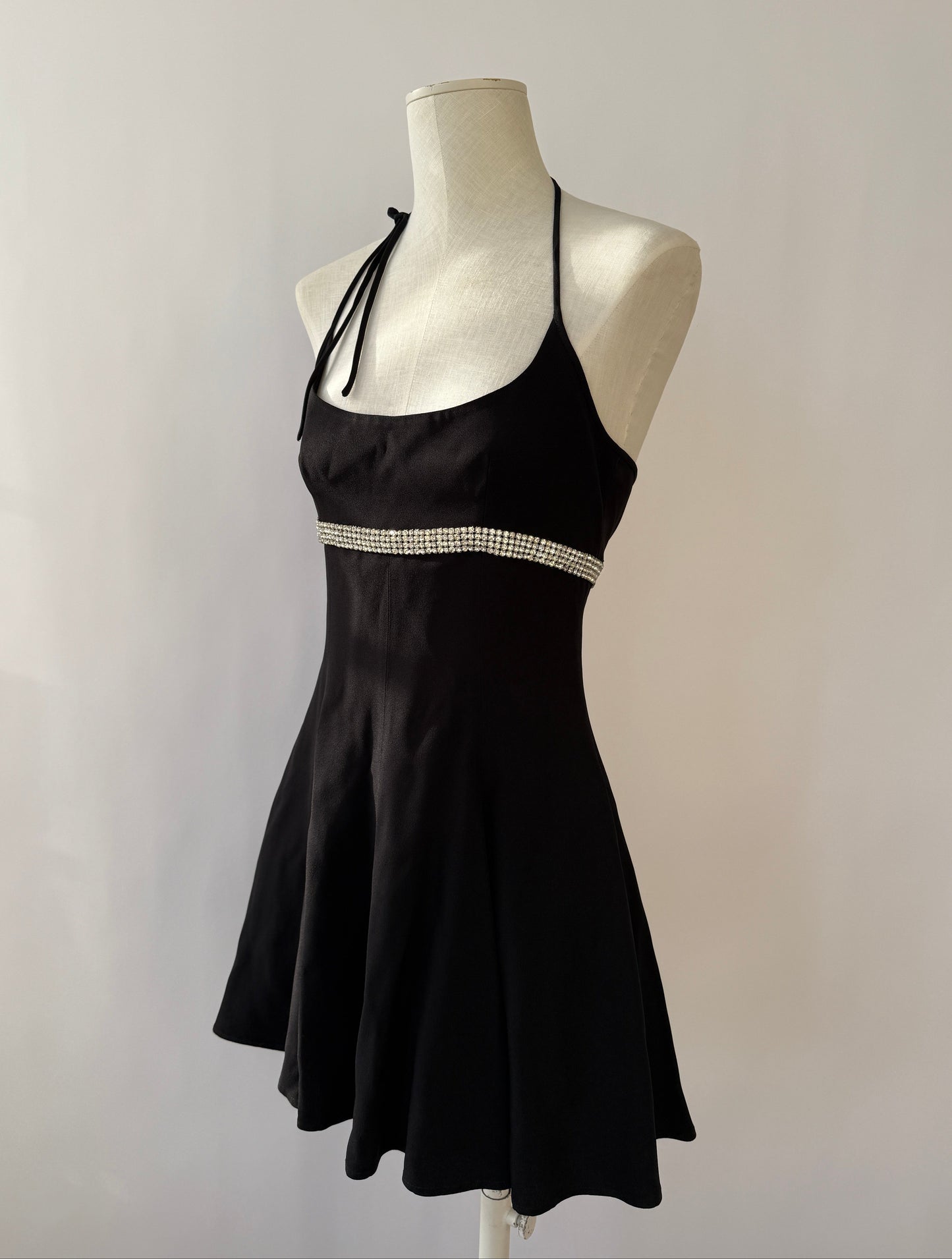 Side view of the Dolce & Gabbana 1995 rhinestone halter dress on a mannequin.