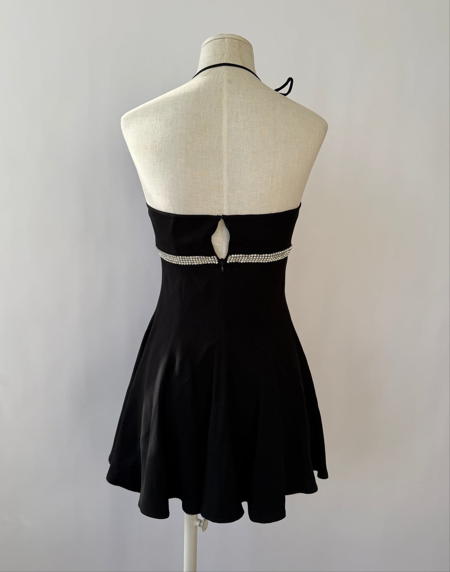 Back view of the Dolce & Gabbana 1995 black rhinestone halter dress on a mannequin.