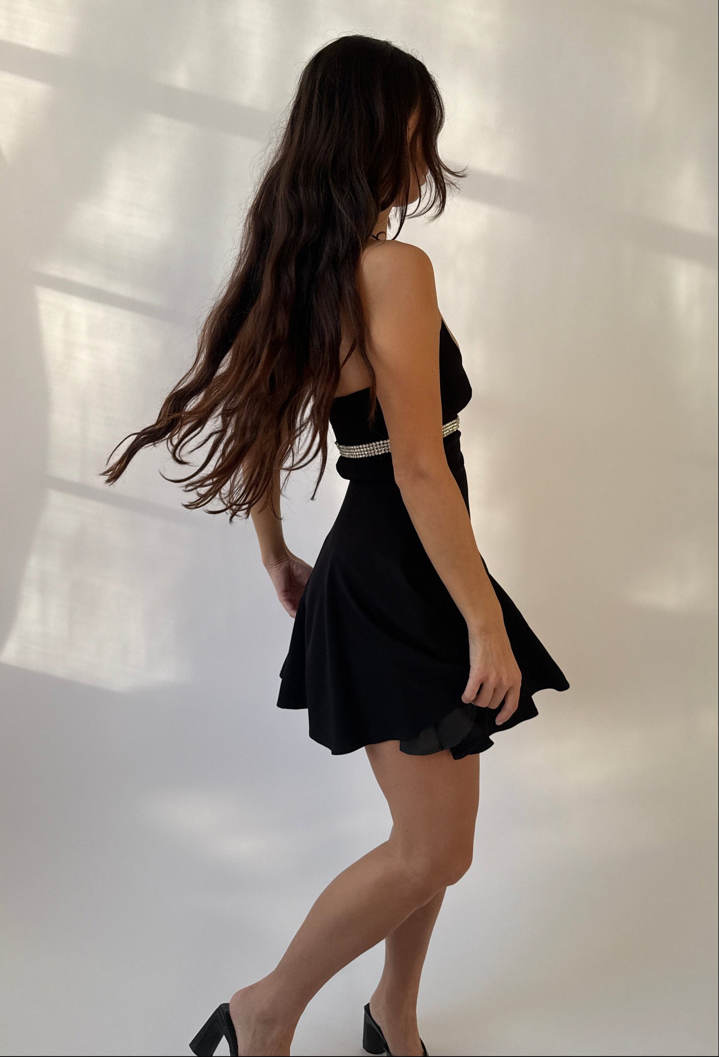 Side view of a model showcasing the Dolce & Gabbana 1995 Rhinestones Halter Dress.