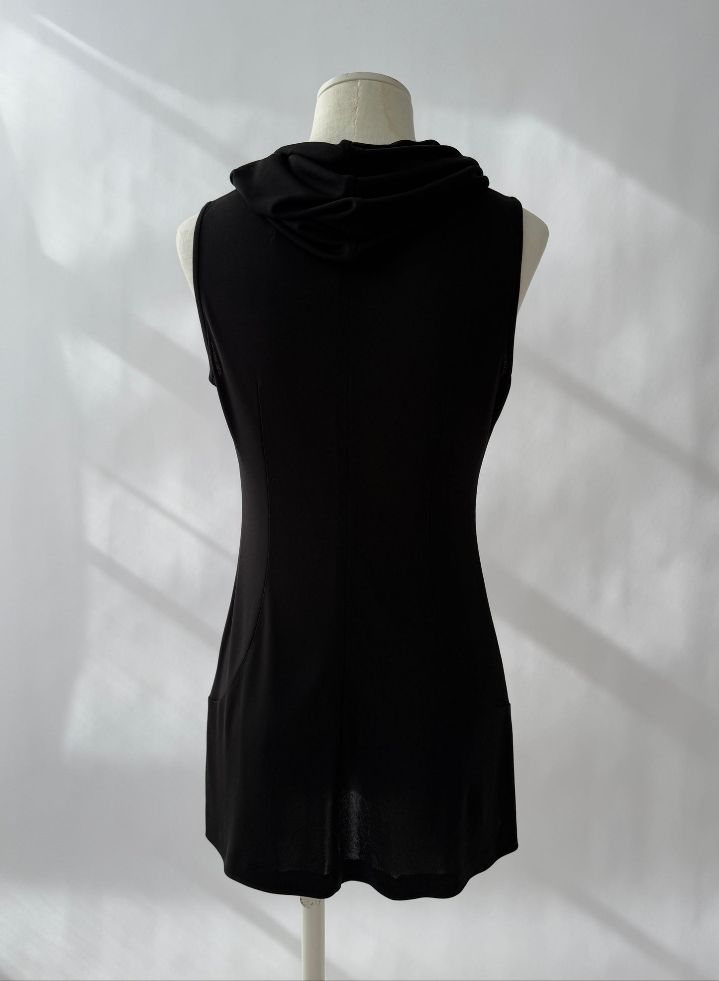 Full length photo of the Dolce & Gabbana 1996 Runway Hooded Mini Dress seen from the back on a mannequin.