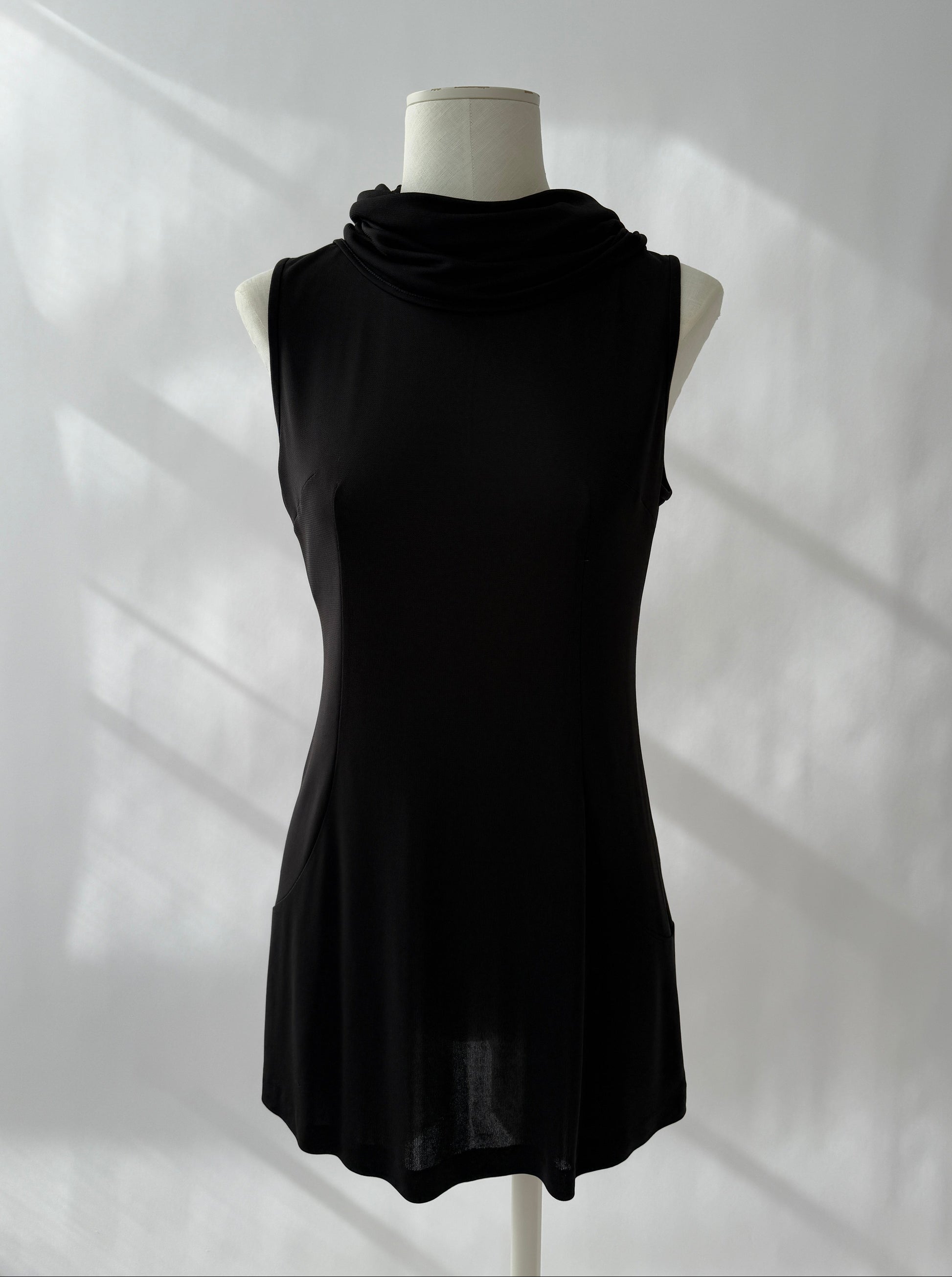 Full length photo of the Dolce & Gabbana 1996 Runway Hooded Mini Dress seen from the front on a mannequin.