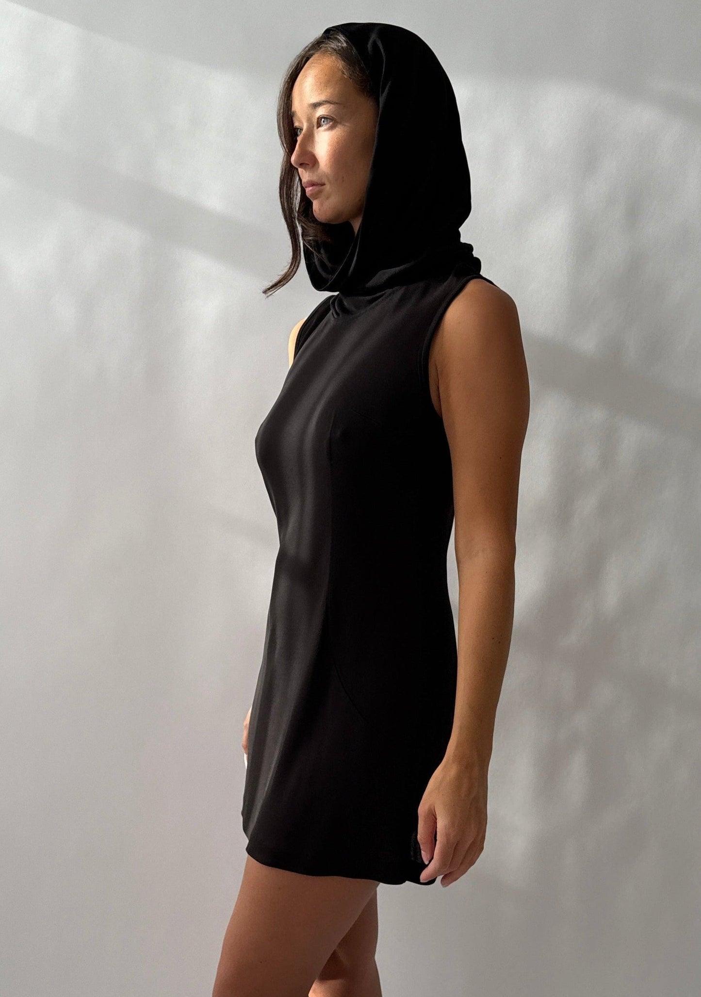 Side front view of the Dolce & Gabbana 1996 Runway Hooded Mini Dress on a model.