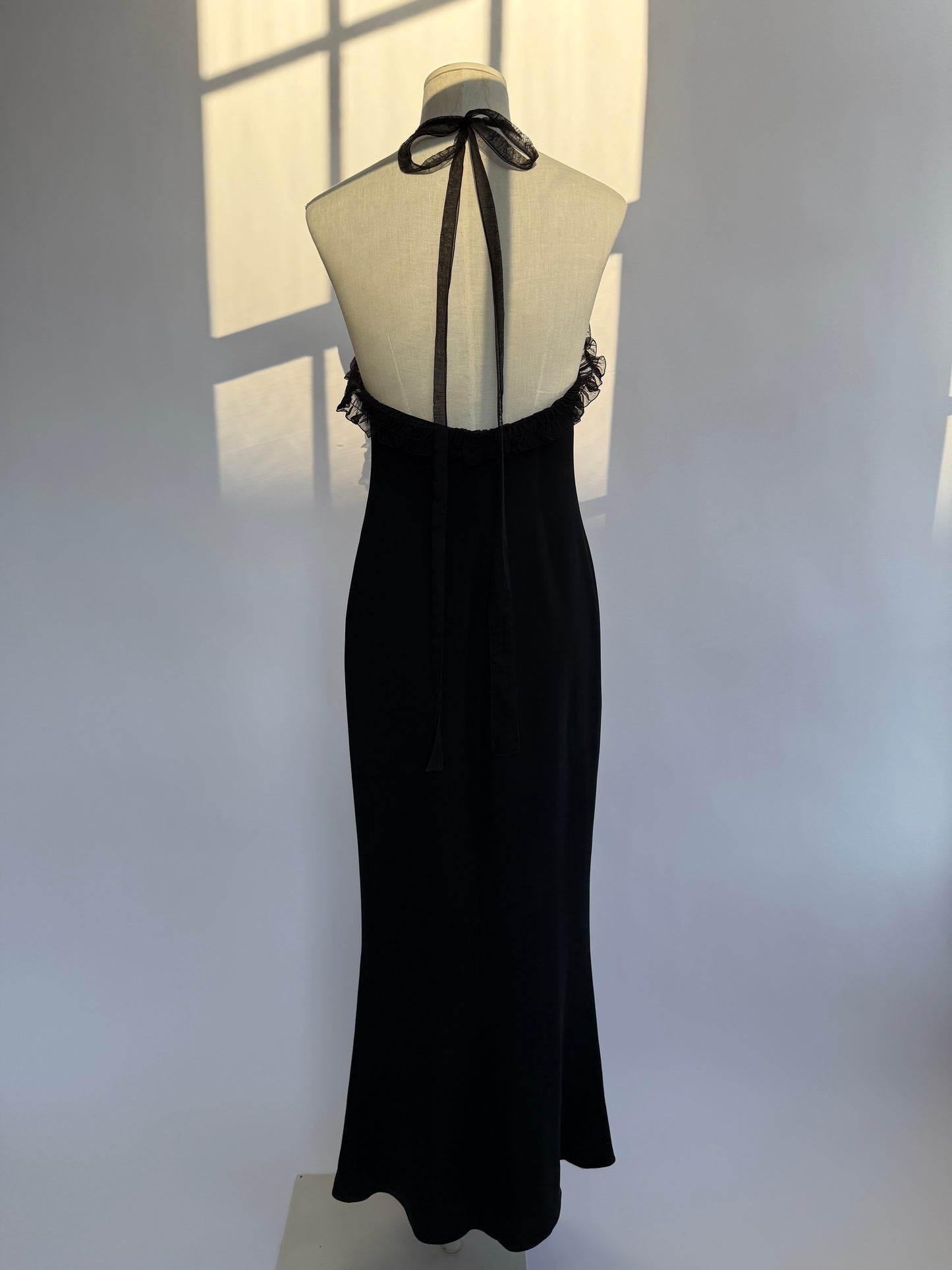 Full length front view of the Emanuel Ungaro 2000's halter neck maxi gown with ruches on a mannequin.