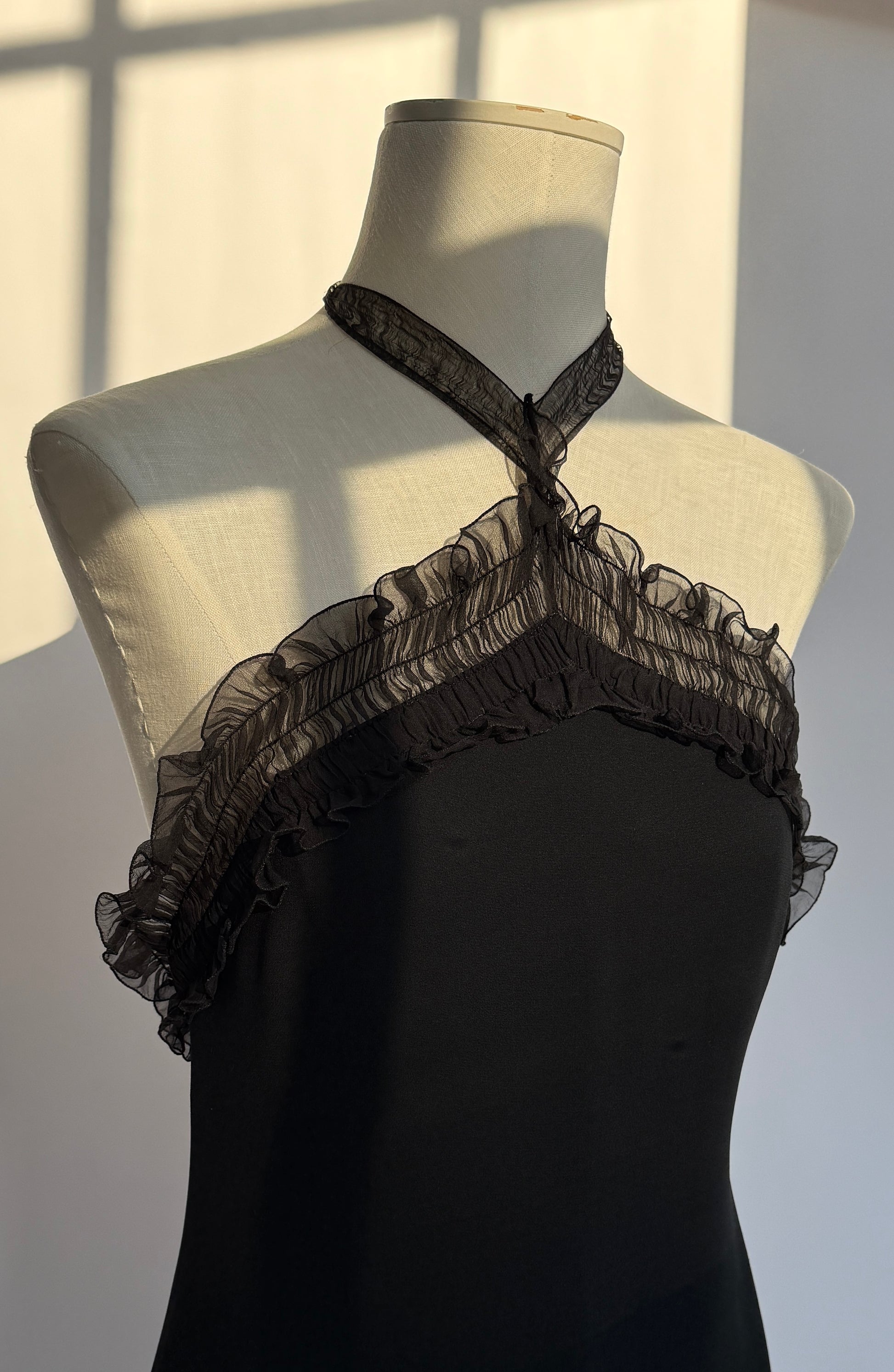 A front view of the top part of the Emanuel Ungaro silk halter neck gown, showcasing the beautiful ruches along the neckline.