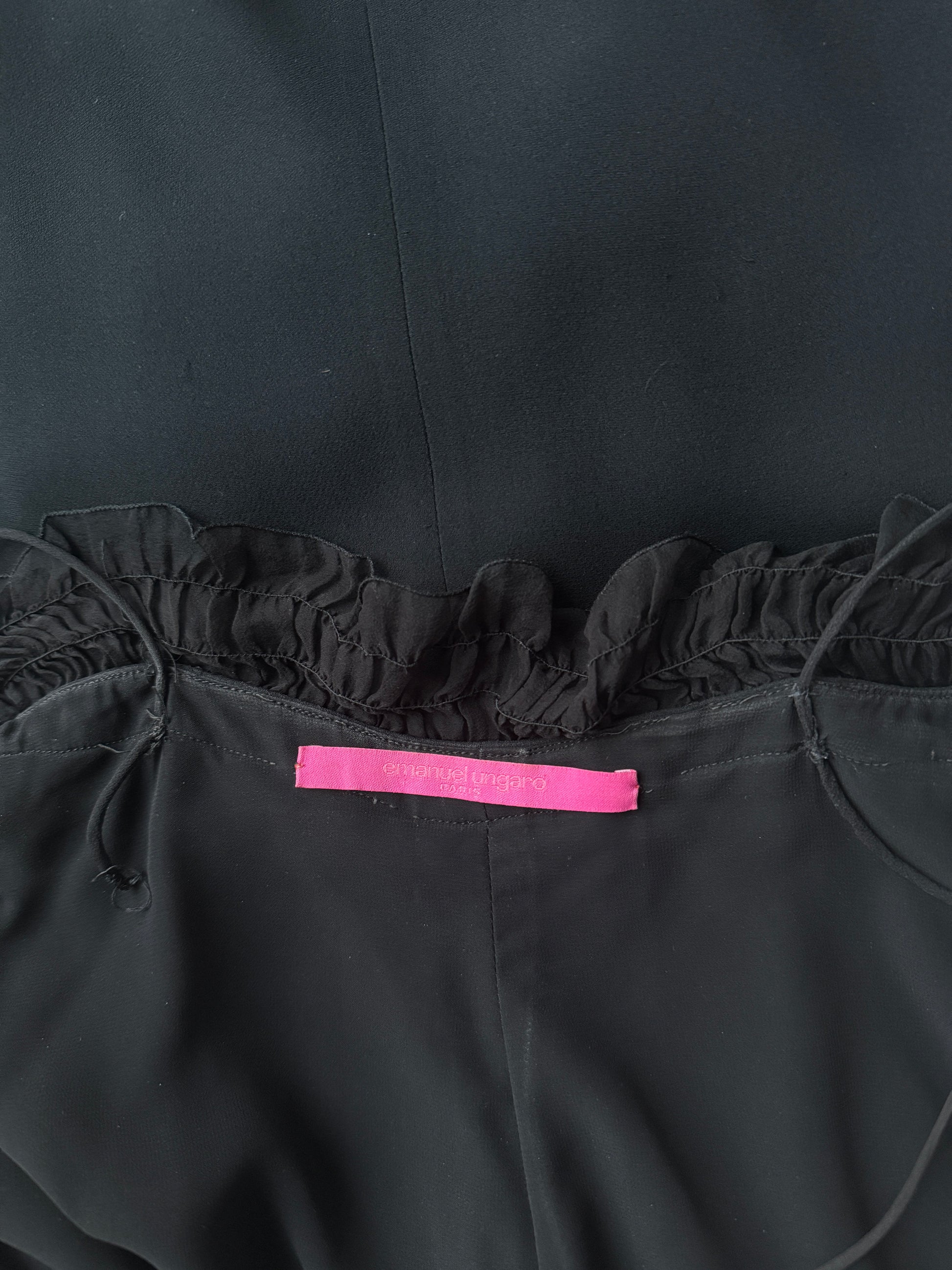 Zoomed in detail photo of the brand label of the Emanuel Ungaro black ruched gown.