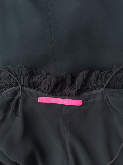 Zoomed in detail photo of the brand label of the Emanuel Ungaro black ruched gown.