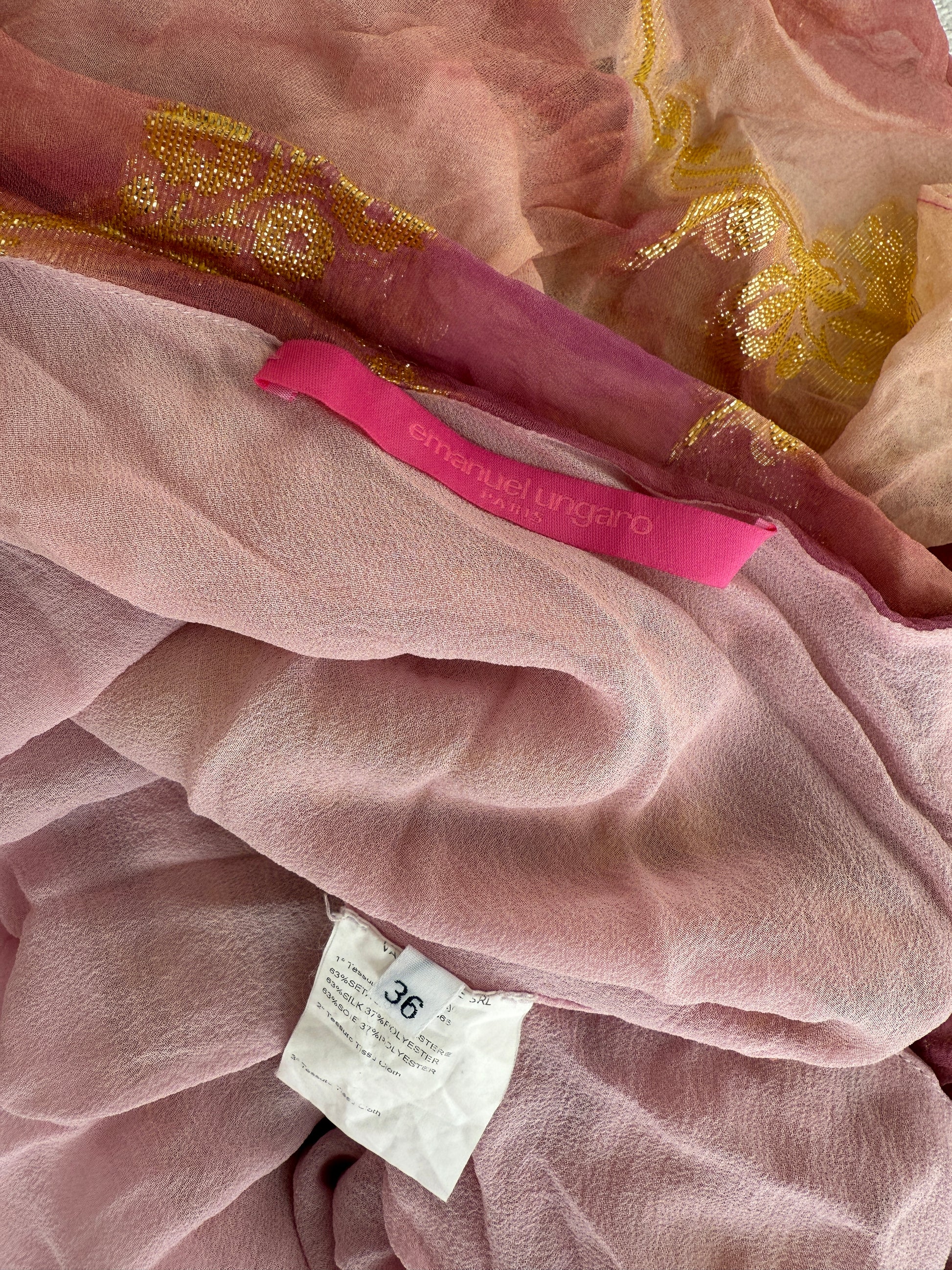 Detail photo of the pink and gold silk fabric of the Emanuel Ungaro silk halter top showing the brand label