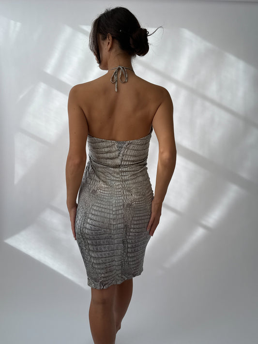 Back view of Roberto Cavalli S/S 2011 crocodile print mini dress with gold halter detail on a model.