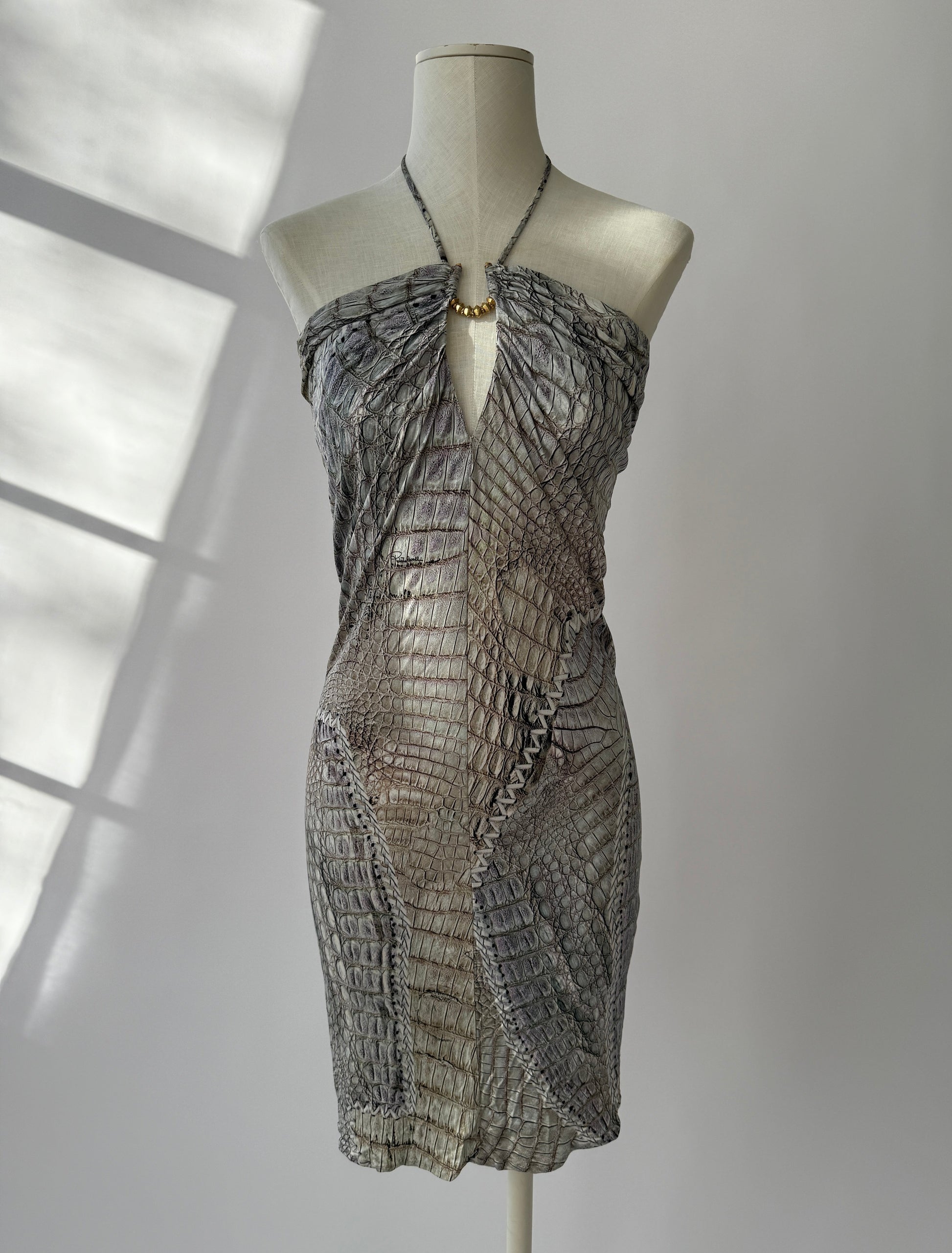 Front of Roberto Cavalli S/S 2011 crocodile print mini dress on mannequin with gold halter detail.
