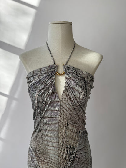 Close-up of crocodile texture and gold hardware on Cavalli mini dress displayed on mannequin.