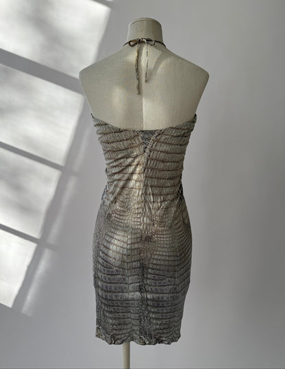 Roberto Cavalli S/S 2011 Crocodile Print Halter Neck Mini Dress with Gold Detail in the sunshine on a mannequin shown from the back side.
