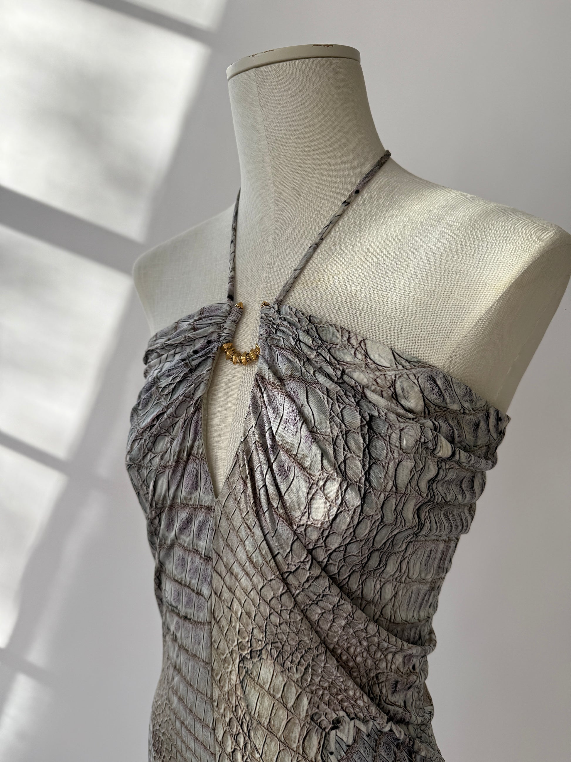 Cavalli 2011 crocodile print dress shown from the side on a mannequin showing the peephole design and halter strap.