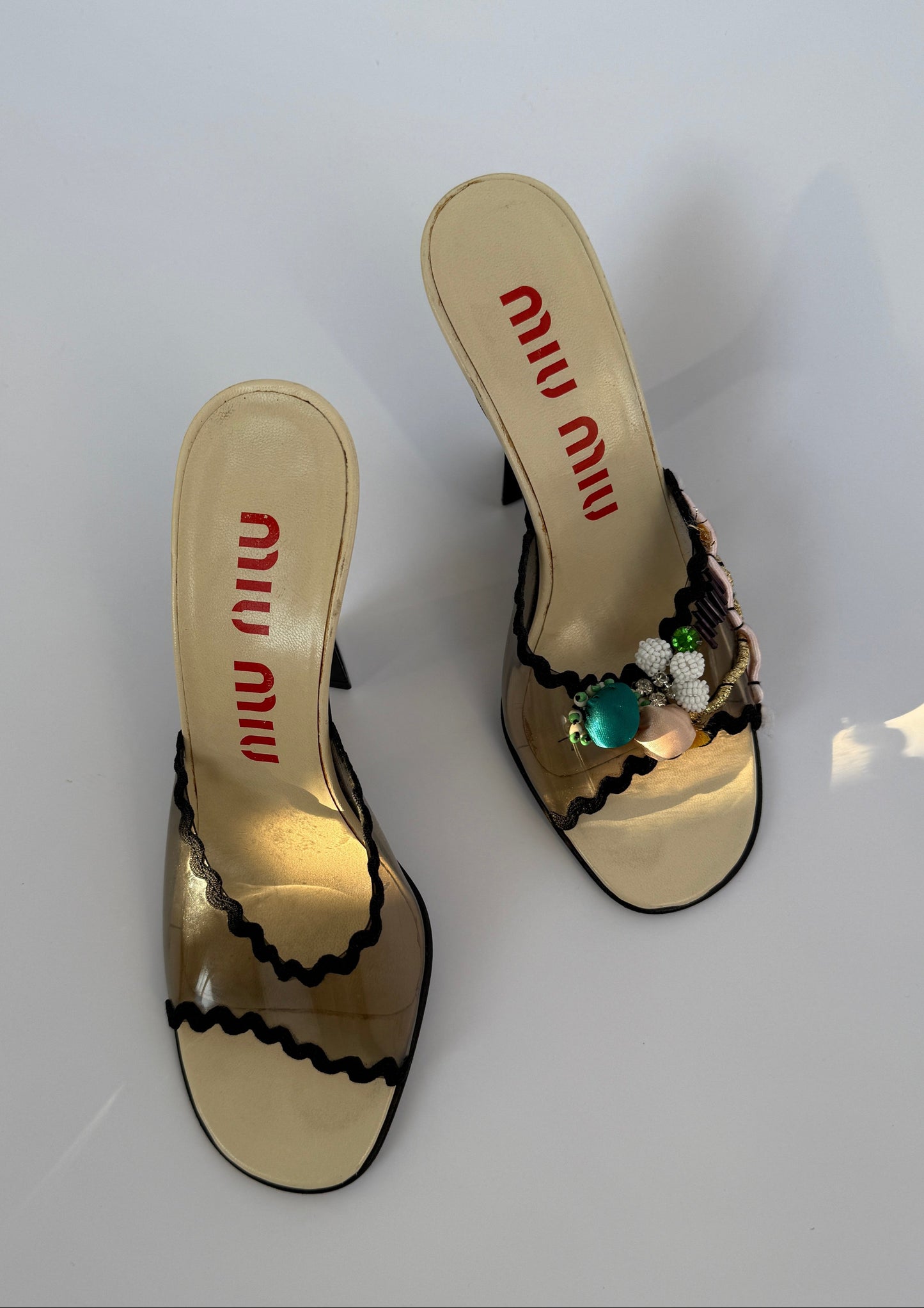 Top view of the Miu Miu S/S 1998 Clear PVC Embroidered Black Squiggle Mules.