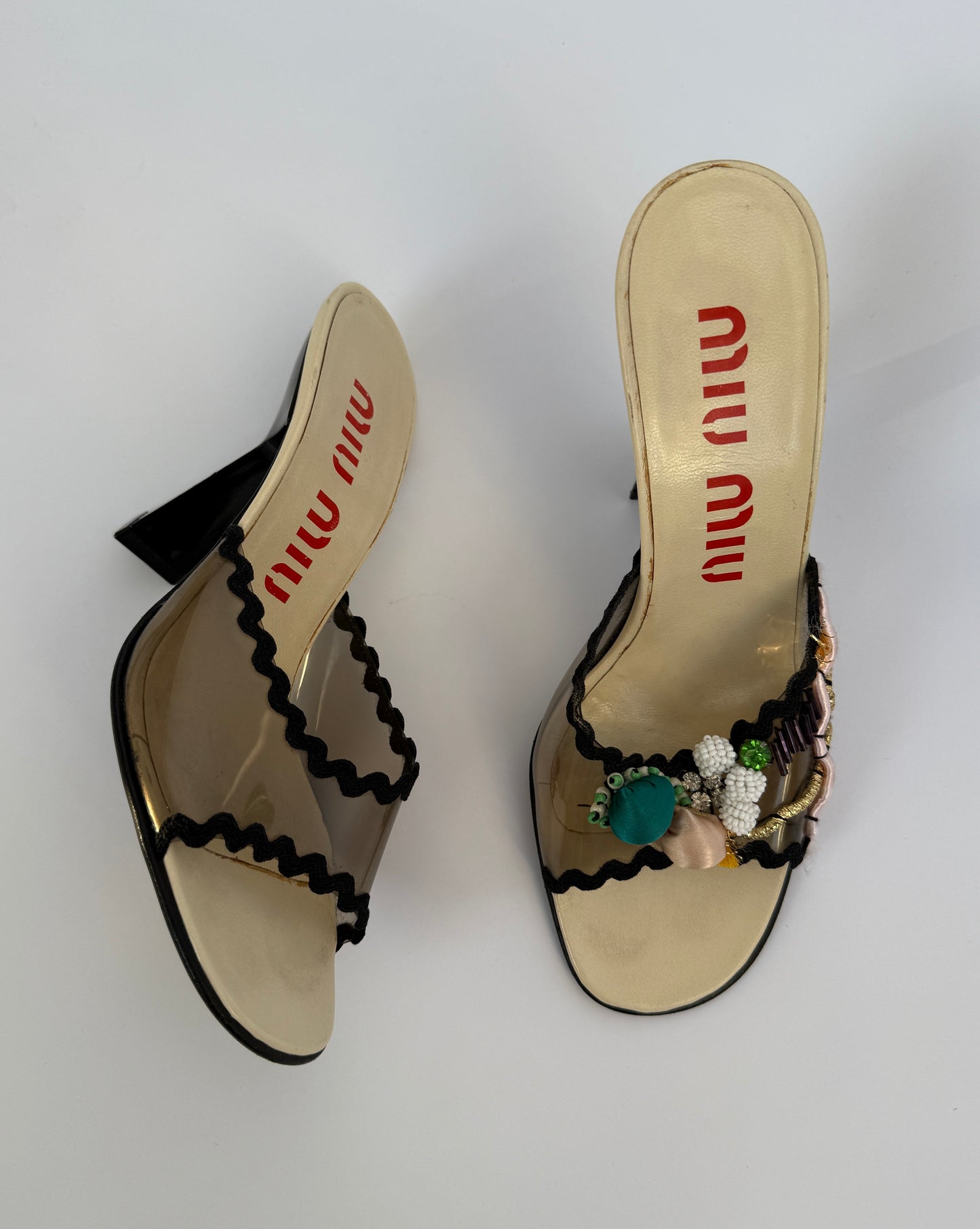 Full length top view of the Miu Miu S/S 1998 Clear PVC Embroidered Black Squiggle Mules showcasing the brand.