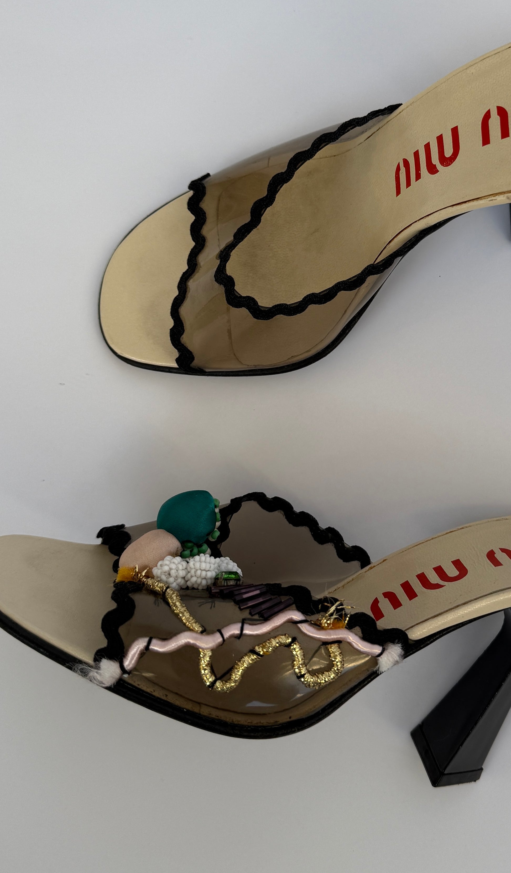 Zoomed in photo on the Miu Miu S/S 1998 Clear PVC Embroidered Black Squiggle Mules, highlighting the embroidery detail.