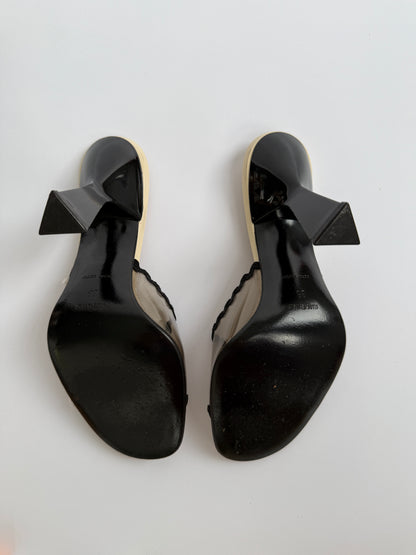 The Miu Miu S/S 1998 Clear PVC Embroidered Black Squiggle Mules shown from the bottom, showcasing the unworn soles.