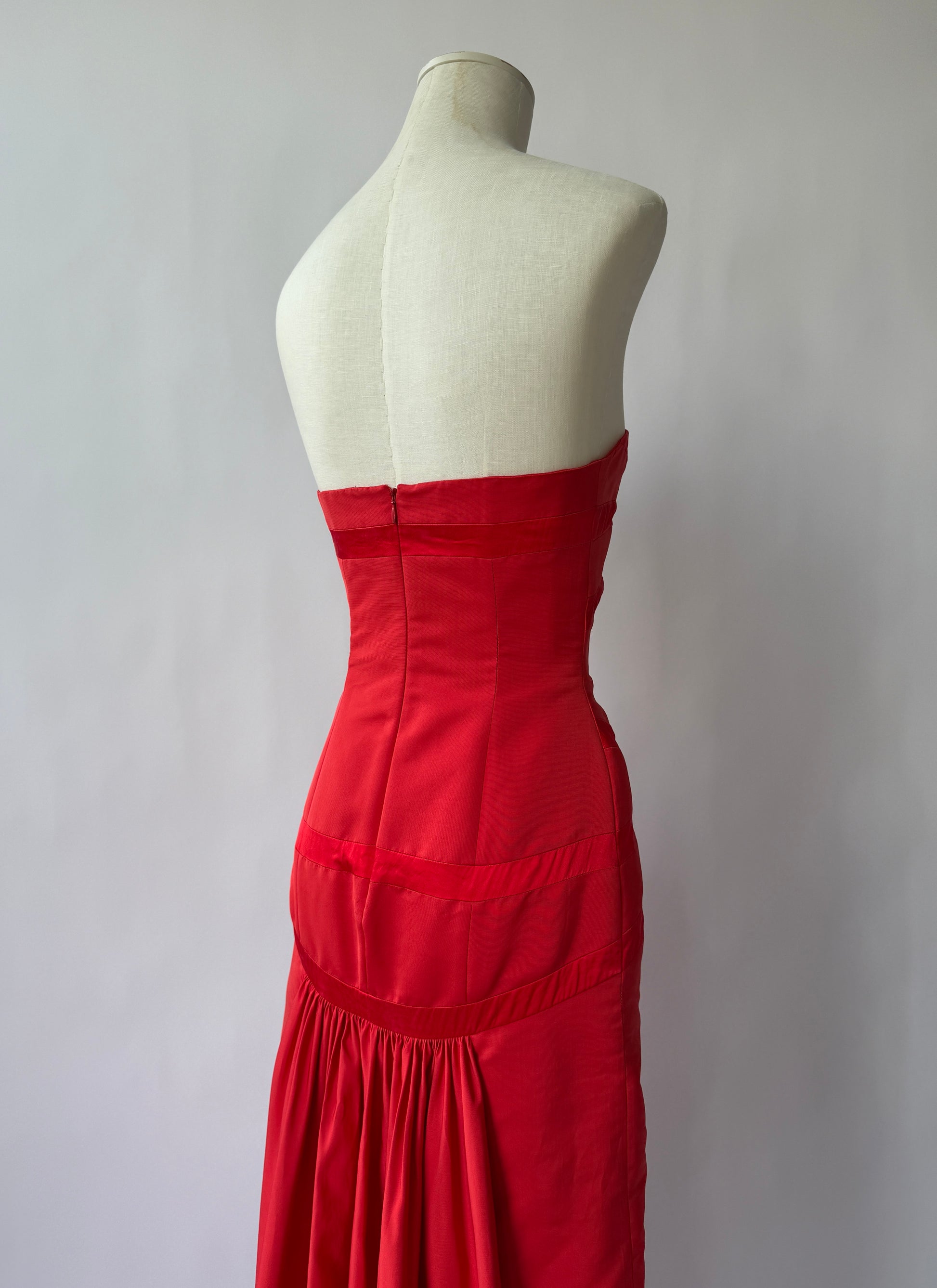 Close up of back of the Valentino Strapless Red gown on a mannequin viewed from the back