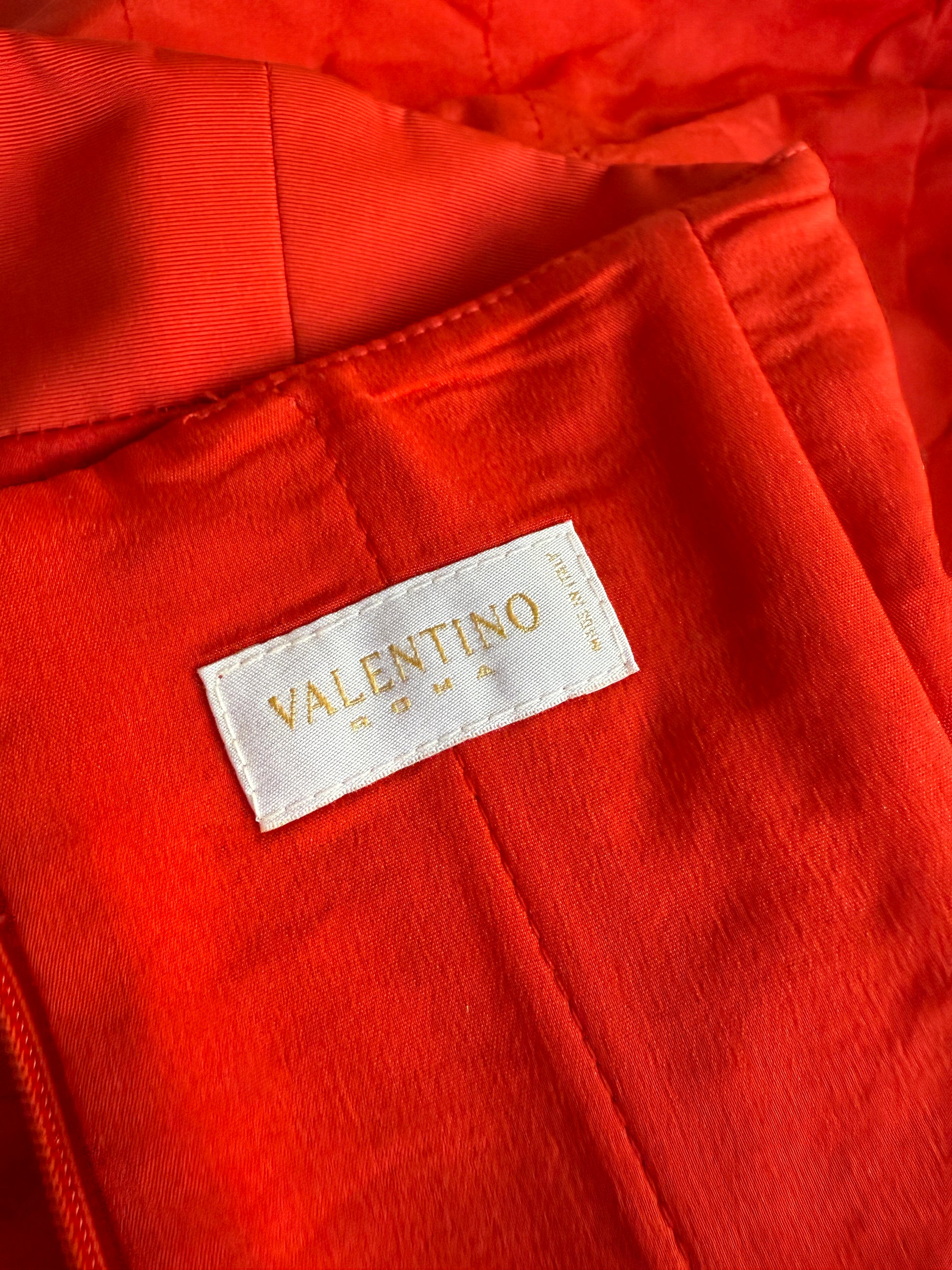 Detail photo of the brand label of the vintage Valentino red gown