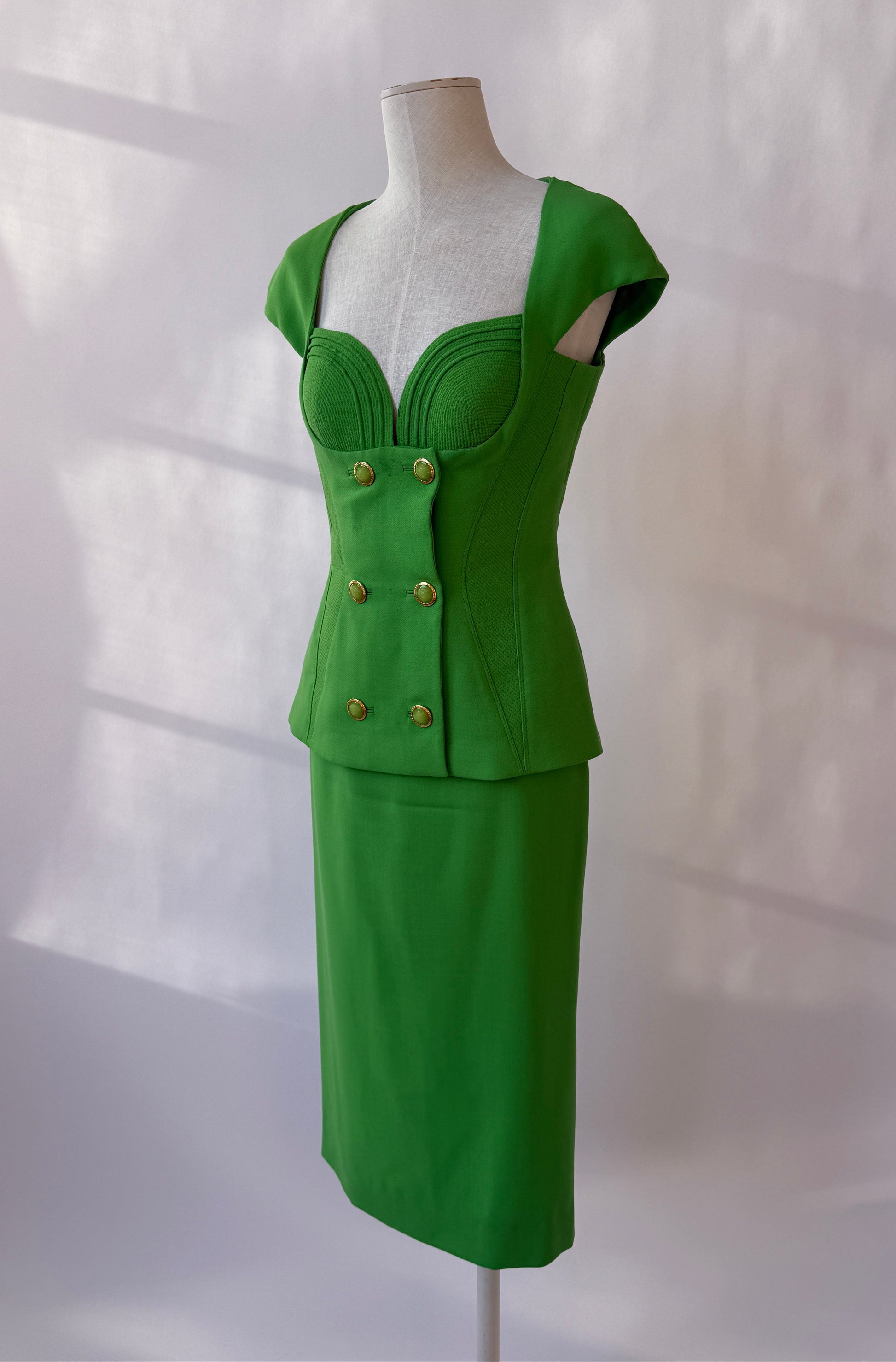 Side front view of the Versace 1993 Vintage Runway Skirt Set on a mannequin.