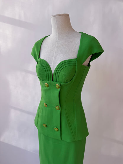 Close-up of the front of the top from the Versace 1993 skirt suit, seen on a mannequin agains a white background.
