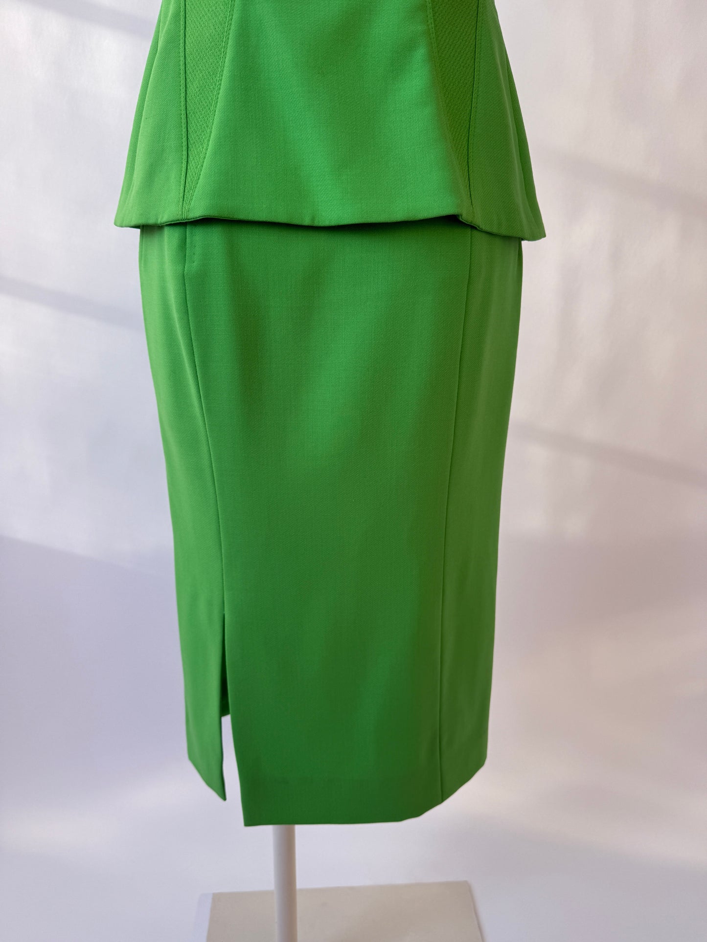 Close-up of the back of the Versace 1993 skirt on a mannequin agains a white background.