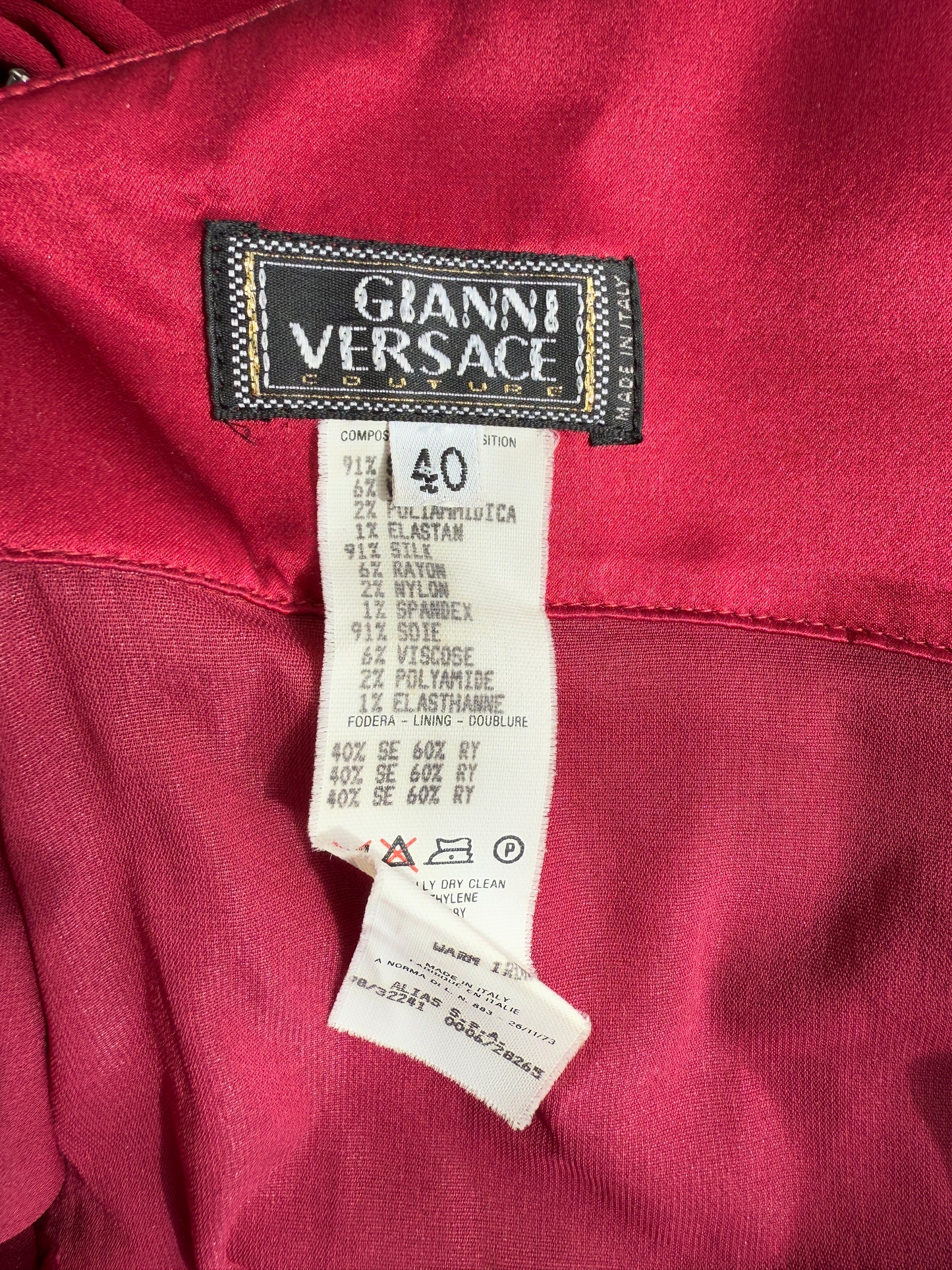 A close-up photo of the brand and composition tag of the Versace 1998 Embellished Gown.